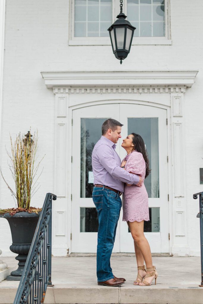 Couple stands in front of the mansion at the Marriott Griffin Gate in Lexington, KY for their engagement session.