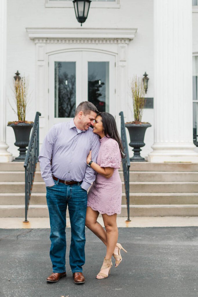 Couple stands in front of the Marriott Griffin Gate in Lexington for their engagement photos.