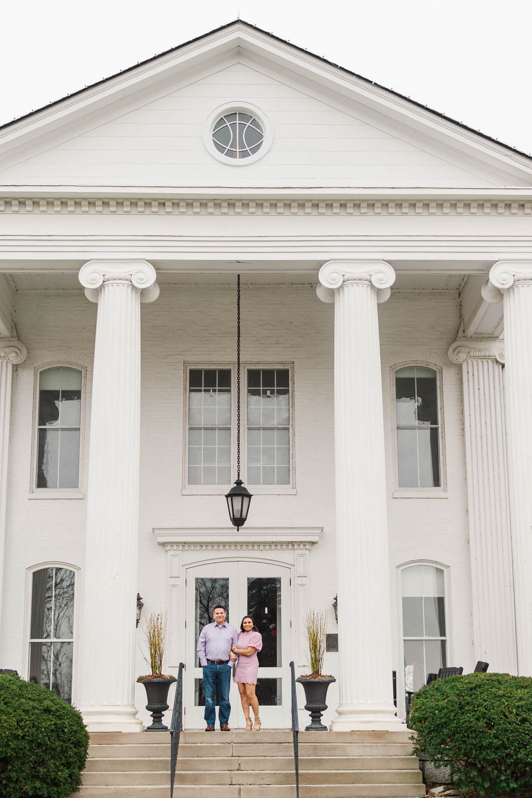 Couple stands in front of the mansion at the Marriott Griffin Gate in Lexington, KY for their engagement session.