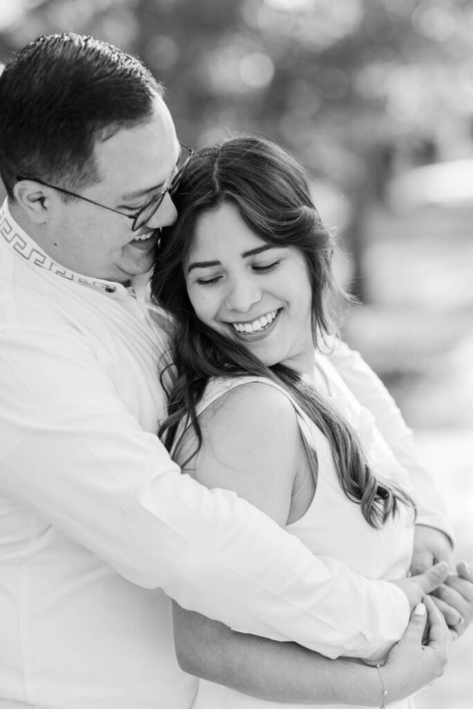 Couple embraces for their engagement session in Norton Commons