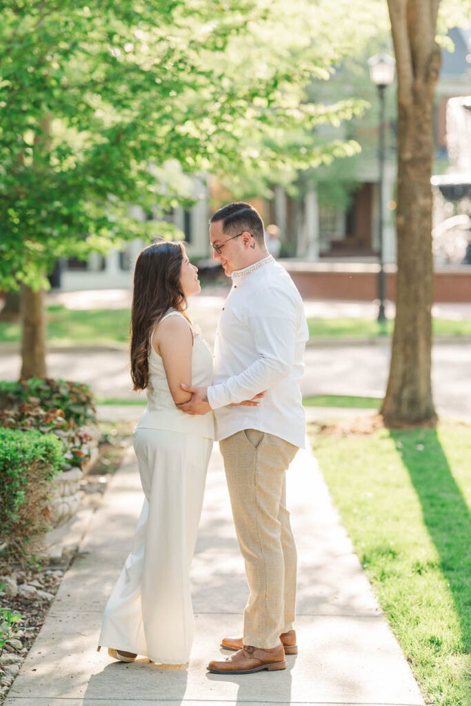 Couple embraces for their engagement session at Norton Commons in Louisville, KY