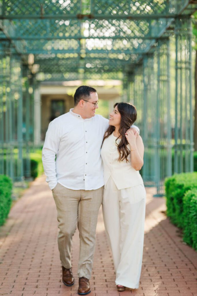 Couple walks towards the camera laughing during their engagement session in Norton Commons