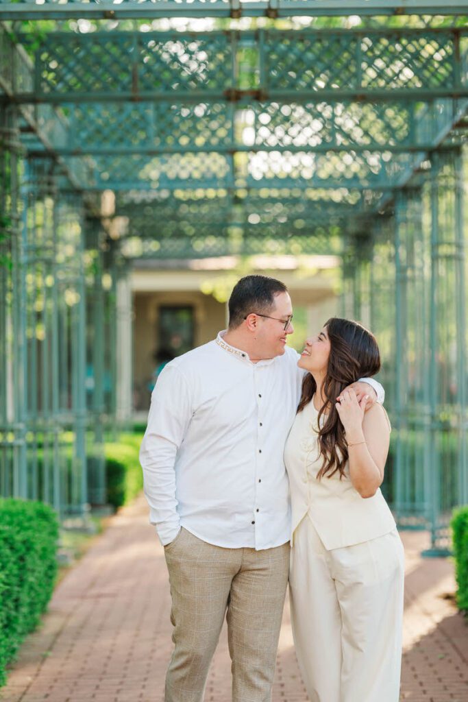 Couple walks towards the camera laughing during their engagement session in Norton Commons