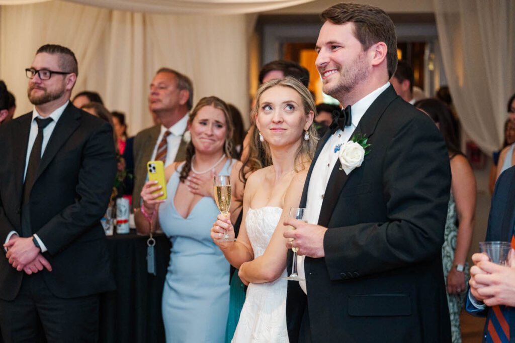 Bride and groom listen to the speeches at their Gardencourt wedding