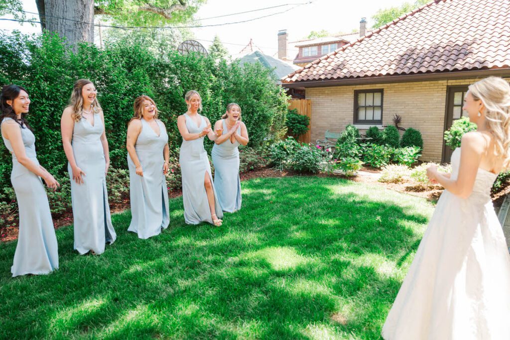 A bride's first look with her bridesmaids after she got in her wedding dress