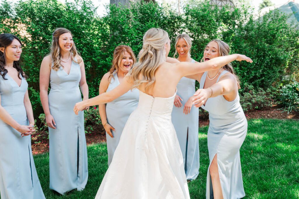 A bride's first look with her bridesmaids after she got in her wedding dress