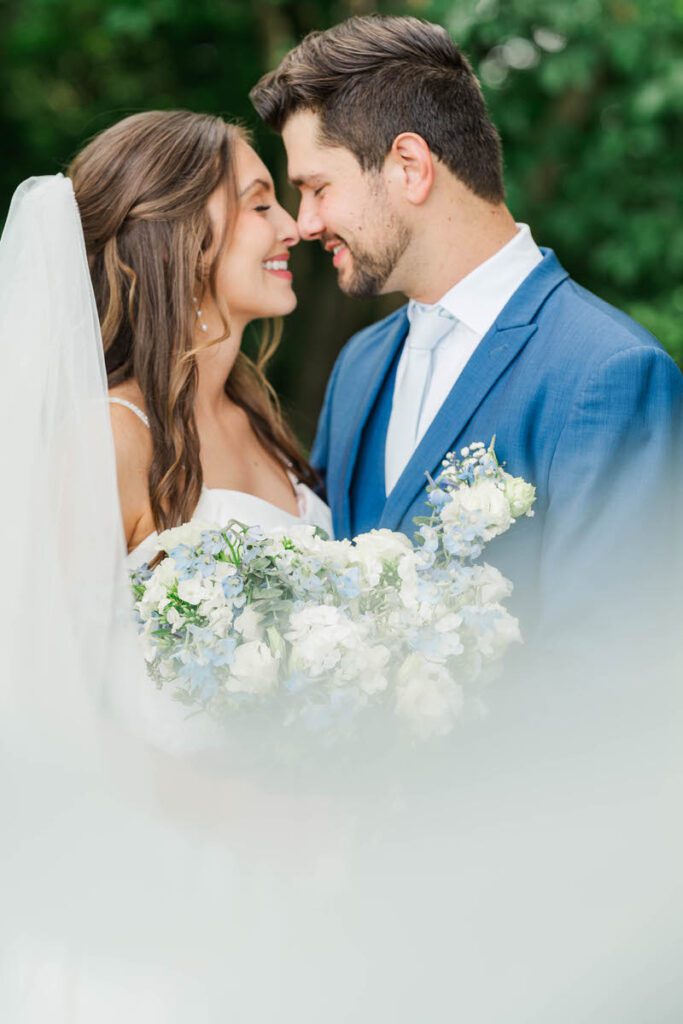 Newly married couple nuzzle together for their bridal portraits at Gheens Foundation Lodge in Louisville, KY