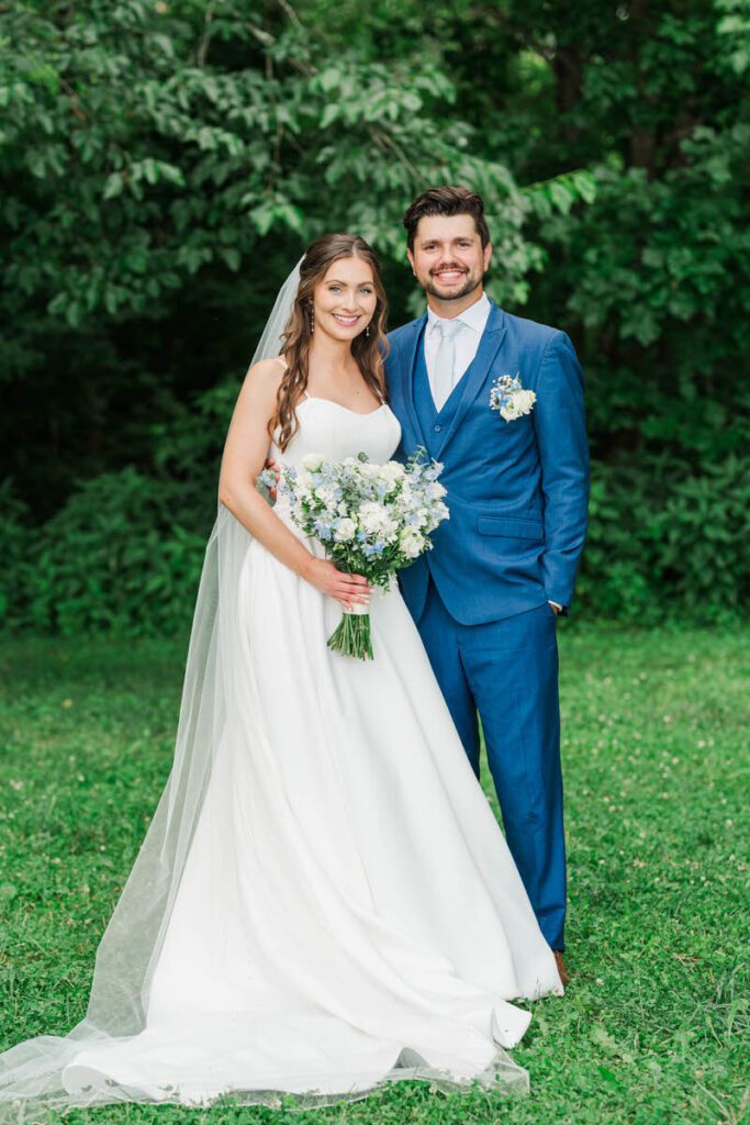 Newlyweds stand together for a portrait at their Gheens Foundation Lodge wedding