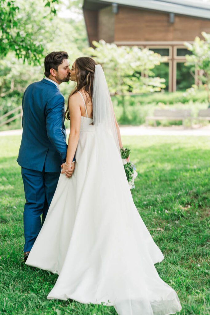 Newlyweds share a kiss at their Gheens Foundation Lodge wedding