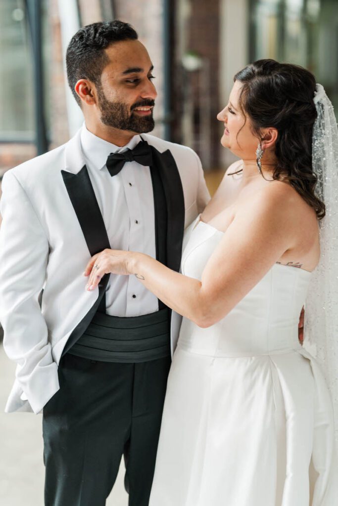 Bride and groom laugh together after their first look on their wedding day at Mellwood Art Center