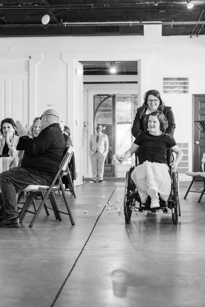Bride's sisters walk down the aisle on her wedding day at Mellwood Art Center