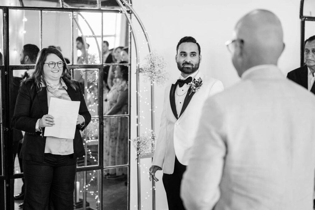 Groom watches the bride walk down the aisle at Mellwood Art Center