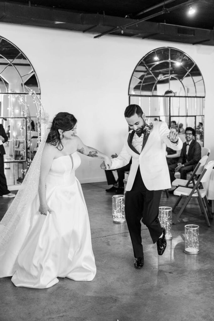 Bride and groom dance down the aisle after getting married on their wedding day at Mellwood Art Center in Louisville, KY