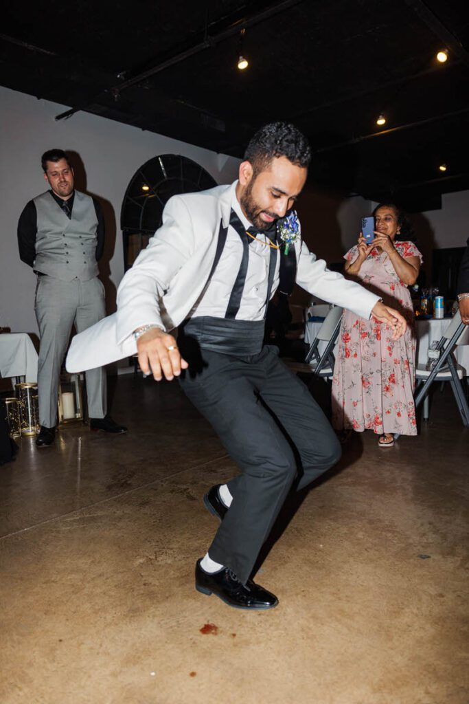 Groom dances on a wedding day at Mellwood Art Center