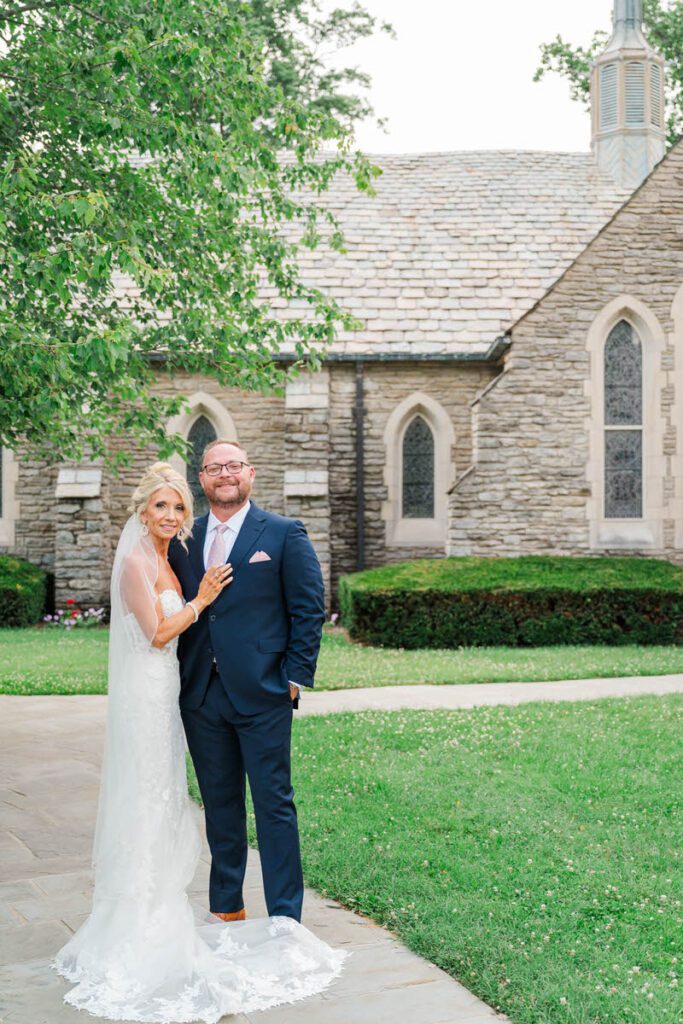 Bride and groom stand in front of their wedding ceremony site, Duncan Memorial Chapel