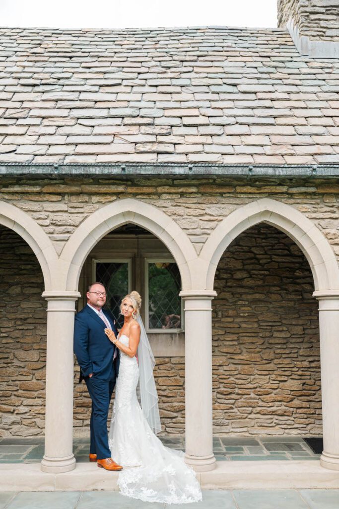 Bride and groom stand in front of their wedding ceremony site, Duncan Memorial Chapel