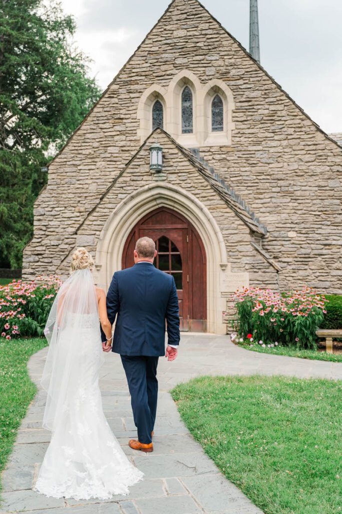 Bride and groom walk to their wedding ceremony site, Duncan Memorial Chapel