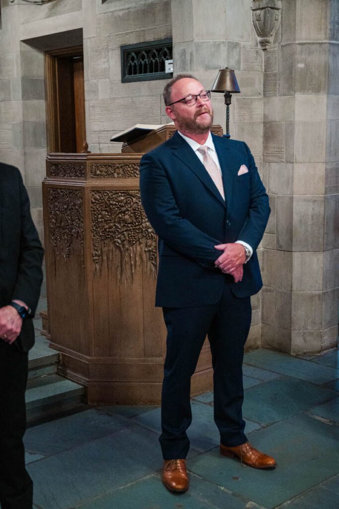 Groom watches his bride walk down the aisle at Duncan Memorial Chapel