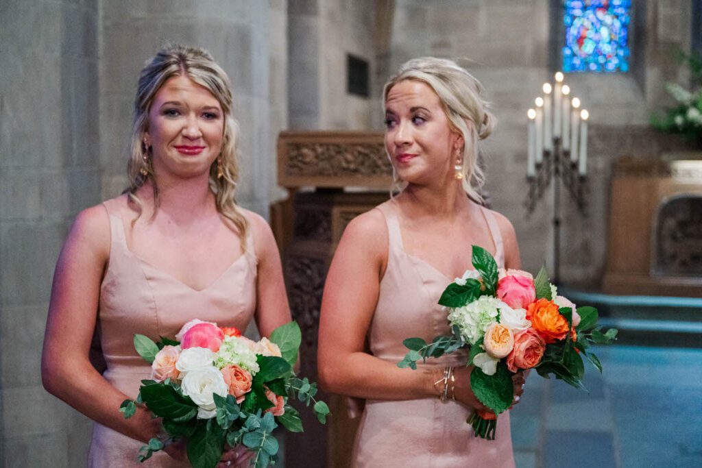 Daughters of the bride tear up as their mom walks down the aisle