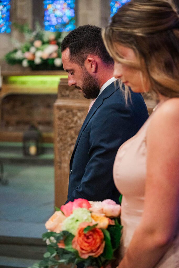 Children of the groom pray during a wedding ceremony at Duncan Memorial Chapel