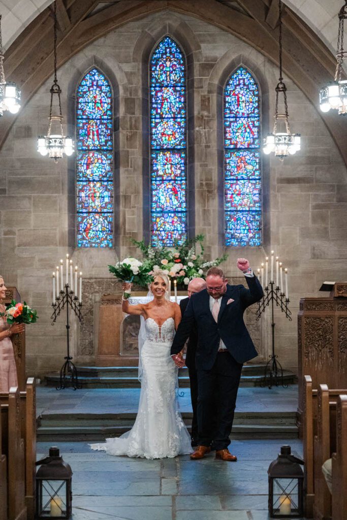 Newlyweds celebrate after their wedding ceremony at Duncan Memorial Chapel