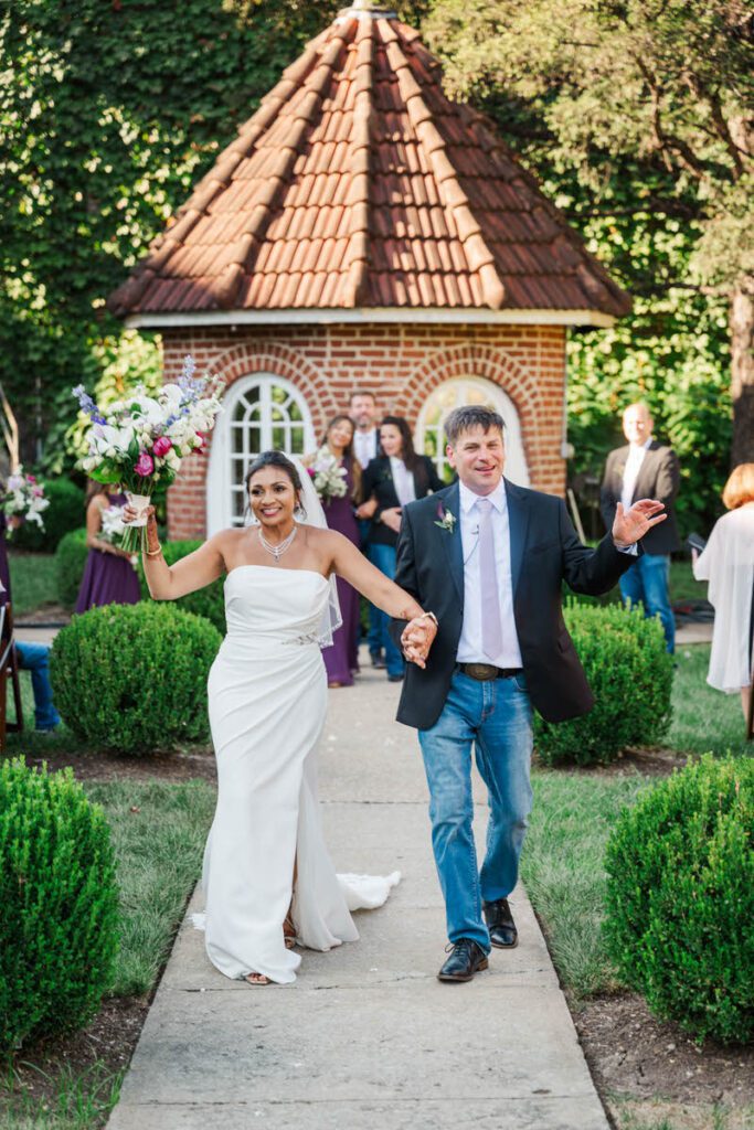 Bride and groom celebrate walking down the aisle at Castle and Key