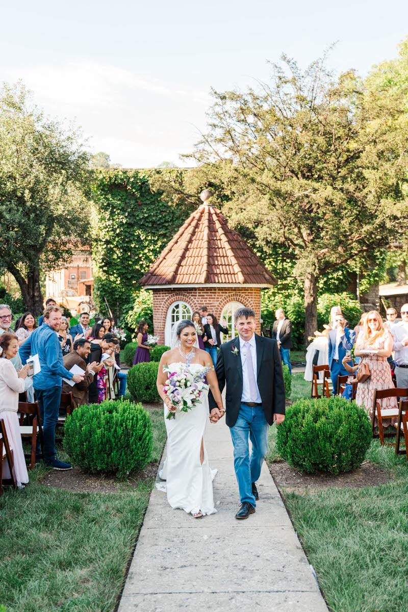 Bride and groom celebrate walking down the aisle at their Castle & Key wedding