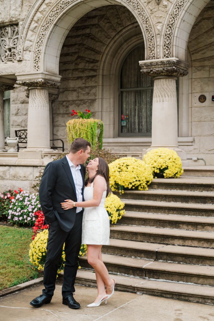 Engaged couple walks down stairs at Saint James Court in Louisville, Ky