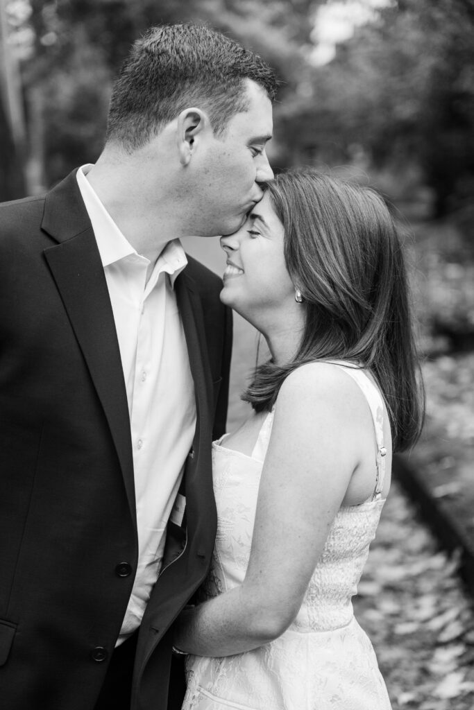 Couple shares a kiss for their engagement session at Saint James Court.
