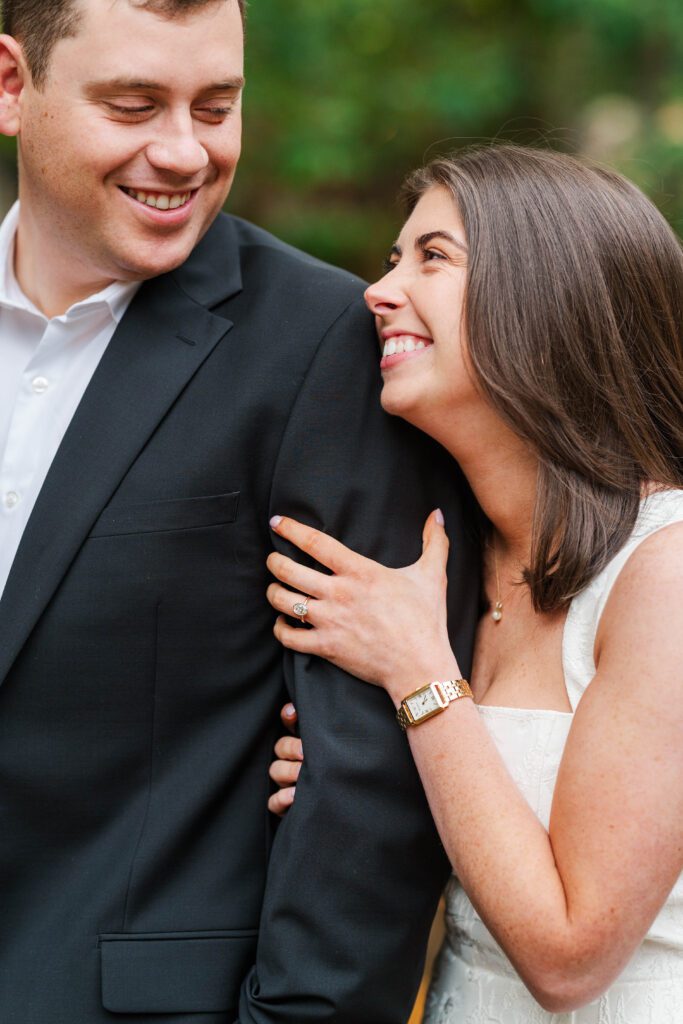 Couple smiles and laughs for their engagement session at Saint James Court.
