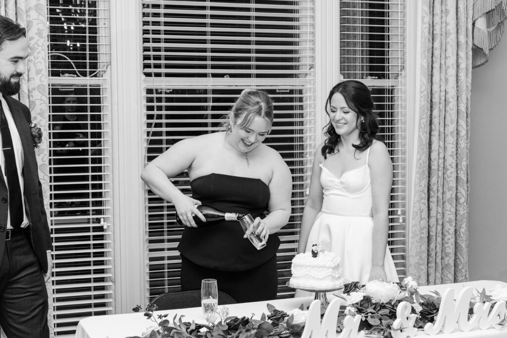 Bride and groom cut the cake on their wedding day at The Bell House