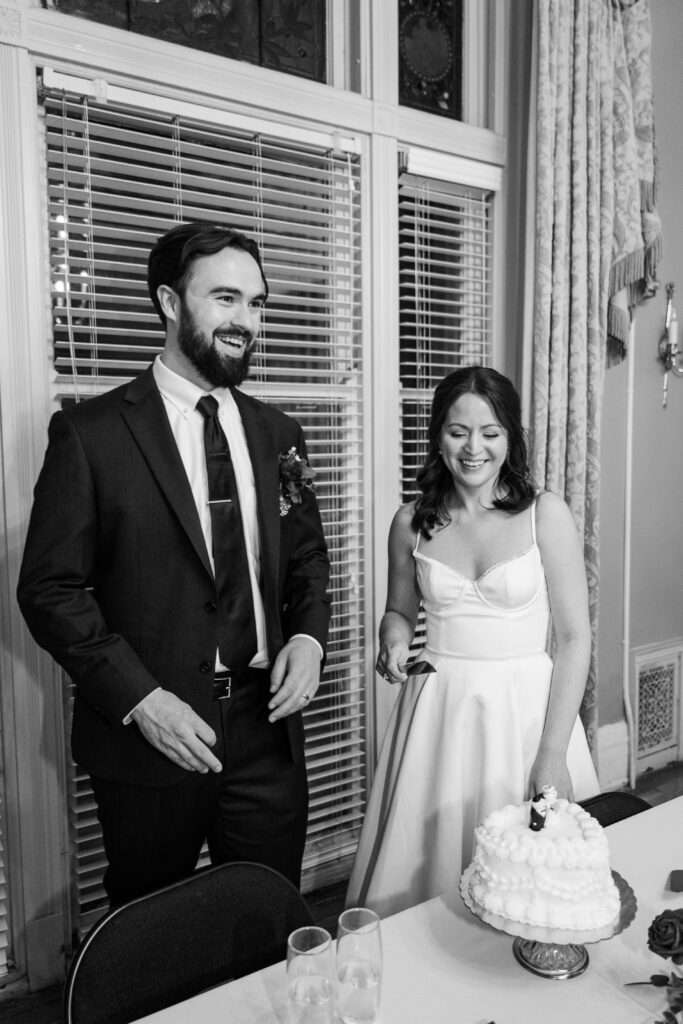 Bride and groom cut the cake on their wedding day at The Bell House