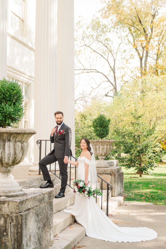 Bride and groom walk up the stairs for their wedding day at The Bell House