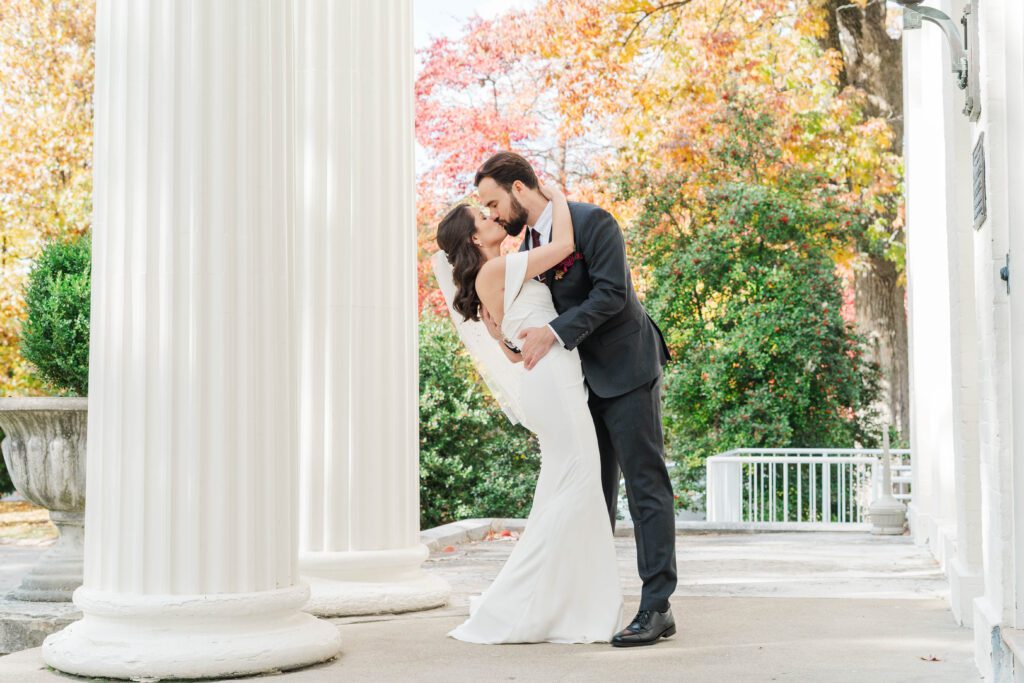 Bride and groom share a kiss at The Bell House for their Lexington wedding day.