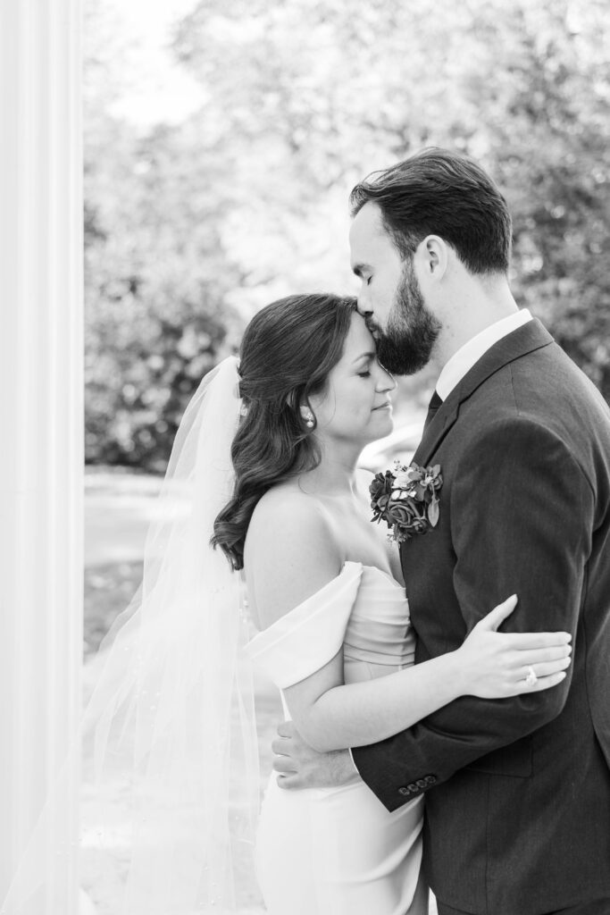 Bride and groom share a kiss at The Bell House for their Lexington wedding day.