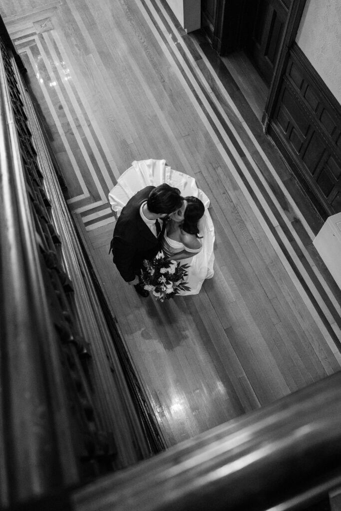 Bride and groom share a kiss inside The Bell House on their wedding day