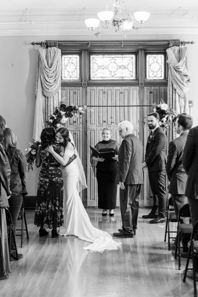 Bride hugs her mother after walking down the aisle for her wedding day at The Bell House in Lexington