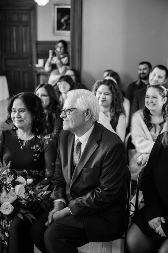 Mother and father of the bride smile during the wedding ceremony at The Bell House in Lexington