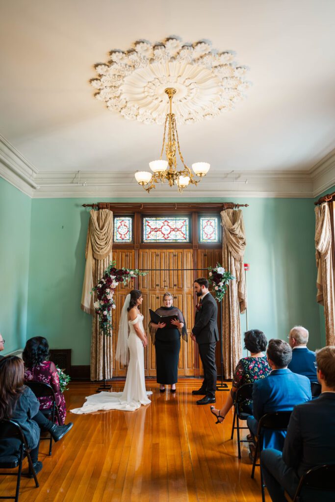 Bride and groom laugh during their wedding ceremony at The Bell House in Lexington