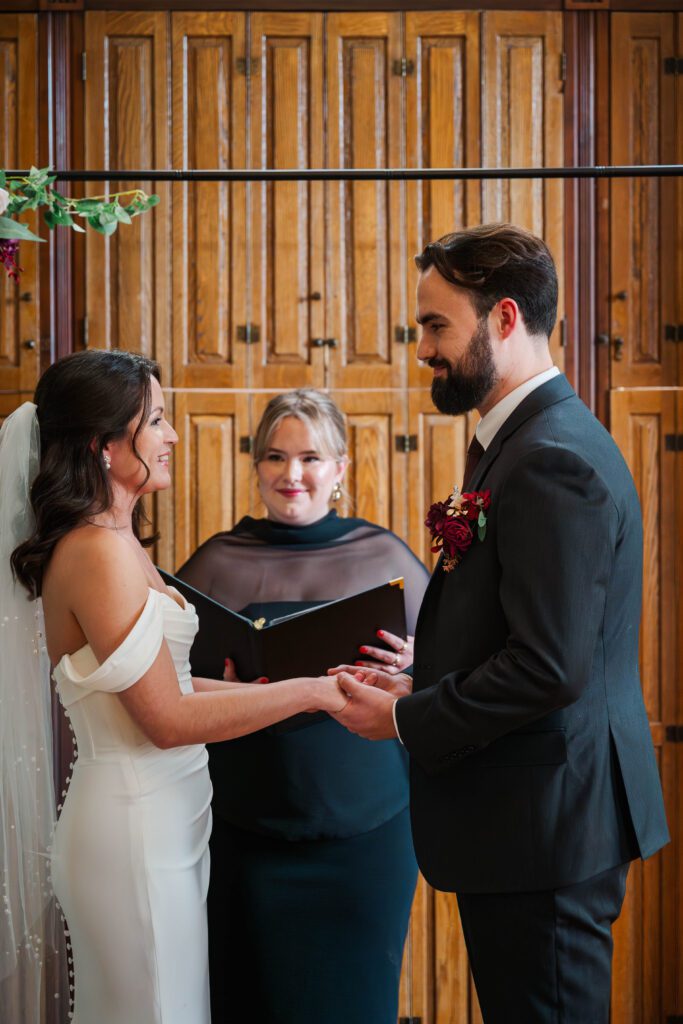 Bride and groom laugh during their wedding ceremony at The Bell House in Lexington