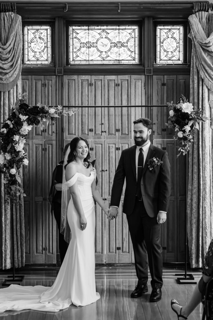 Bride and groom laugh during their wedding ceremony at The Bell House in Lexington