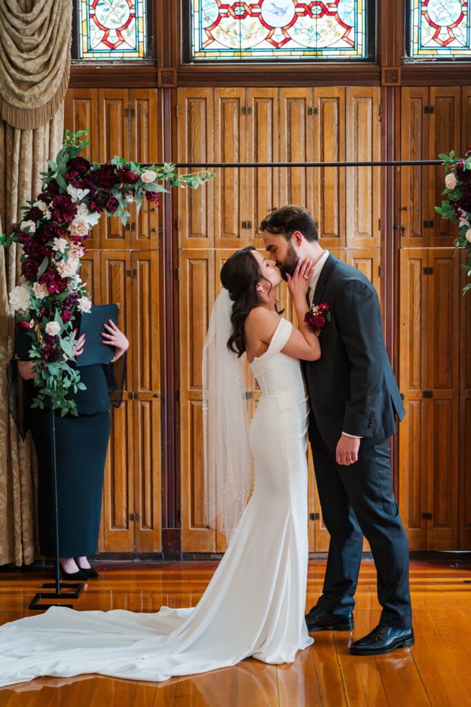 Bride and groom's first kiss on their wedding day at The Bell House