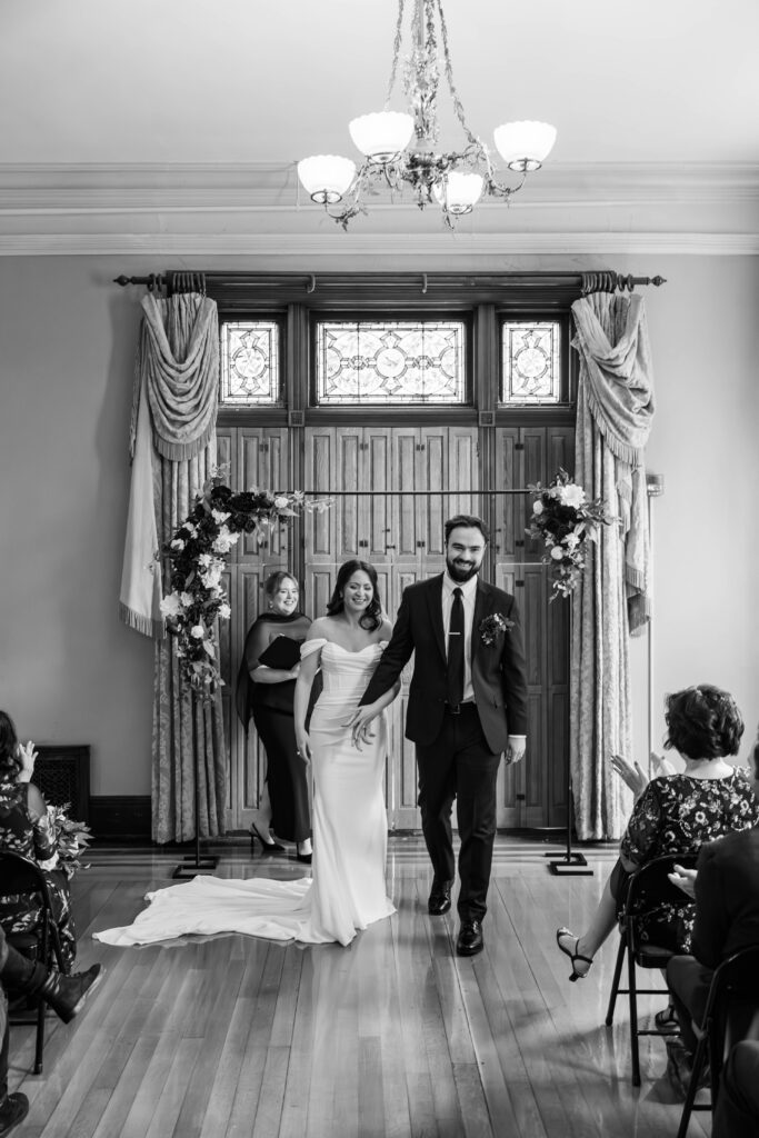 Bride and groom walk down the aisle after getting married at The Bell House in Lexington