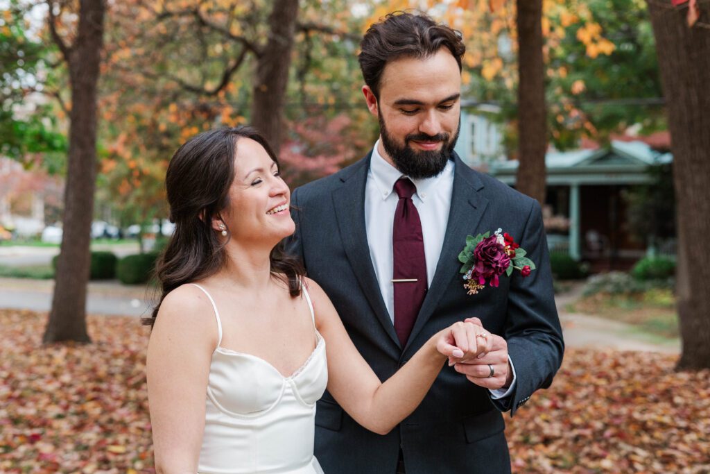 Bride and groom look at their wedding rings after getting married at The Bell House in Lexington