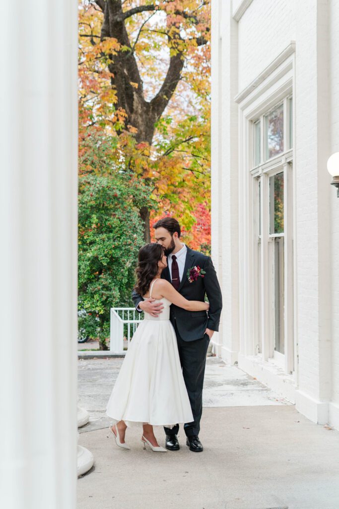 Bride and groom share a kiss at The Bell House for their Lexington wedding day.