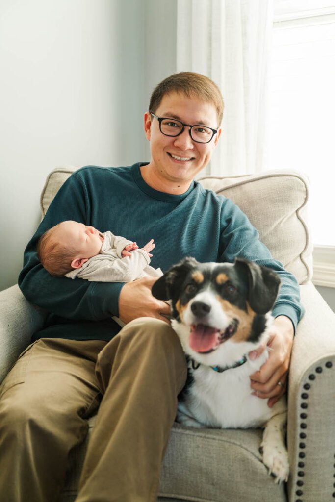 A dad sits in rocker with newborn baby and pup. 

Louisville In-Home Newborn Photographer

Michelle Bordenkircher Photography