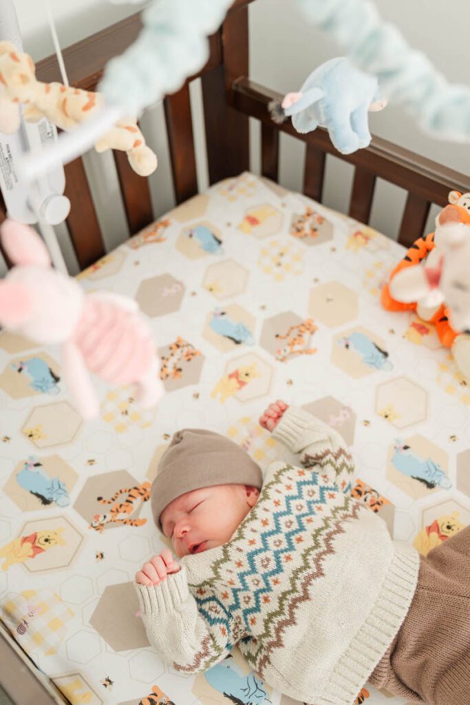 A baby sleeps calmly in his crib.