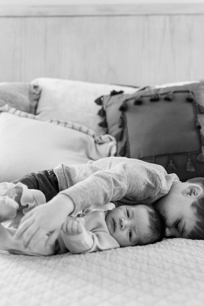 Big brother hugs new baby brother during a Louisville in home newborn session.