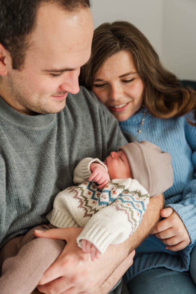 A new mom and dad look proudly at their new baby boy.