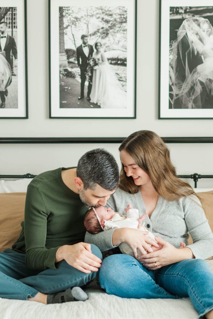 Mom and dad hold baby during their Louisville in-home newborn session.